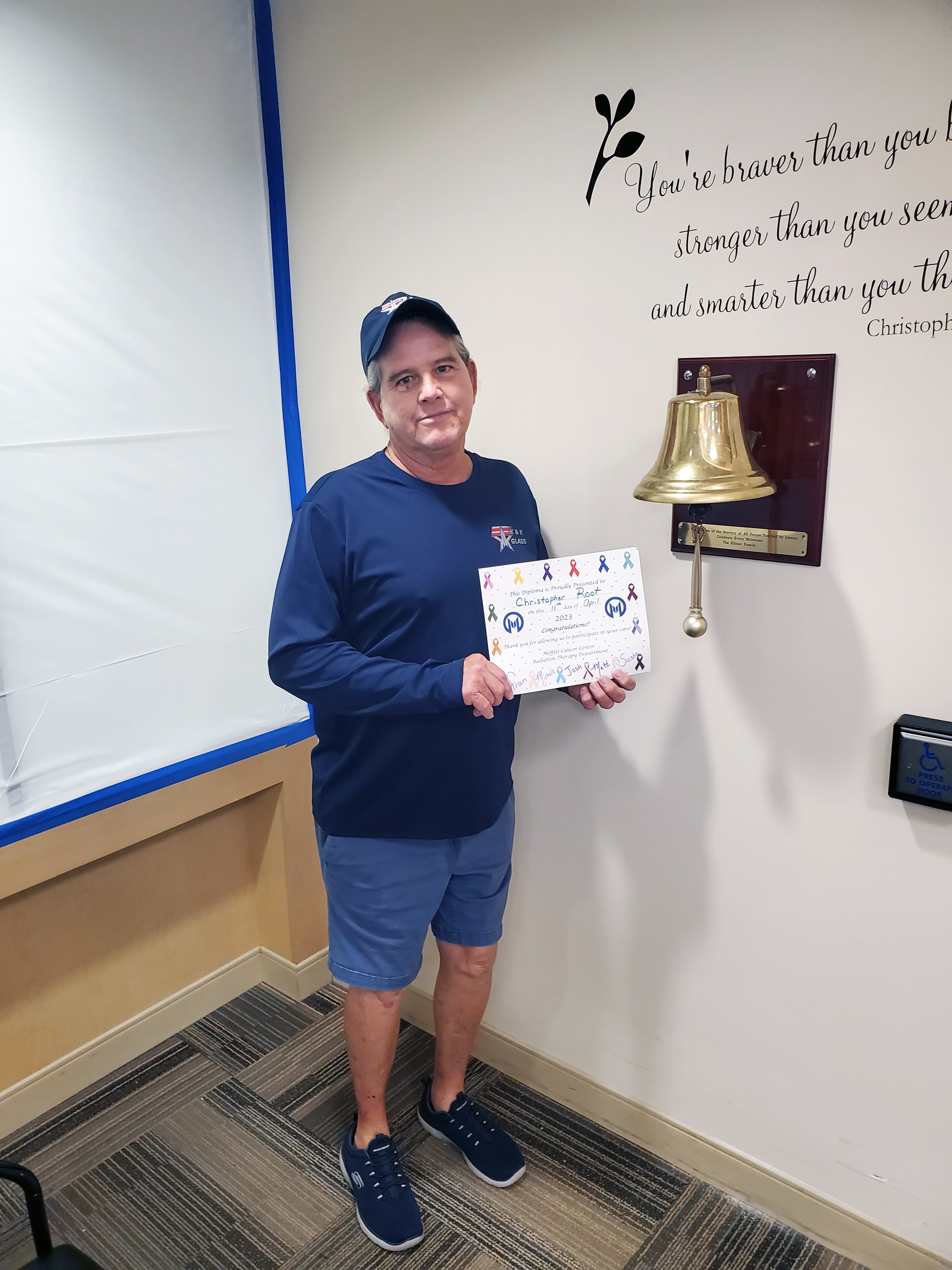 Chris ringing the bell after successfully completing radiation therapy.